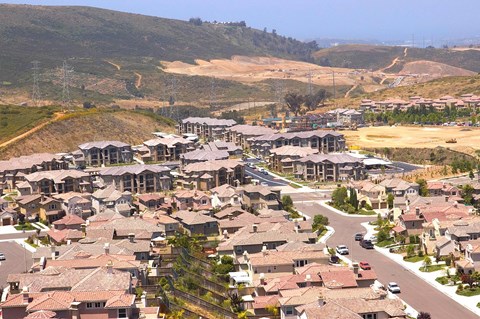 A suburban neighborhood with houses and a road.