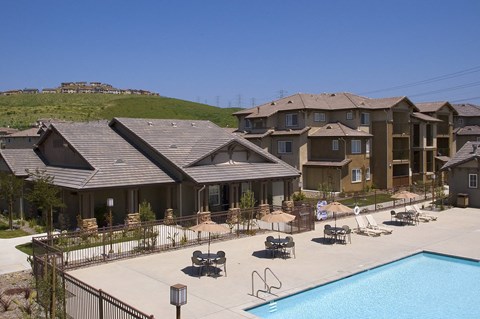A large building with a pool in front.