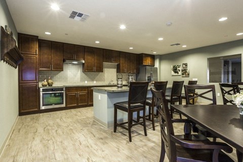 A modern kitchen with dark wood cabinets and a center island.