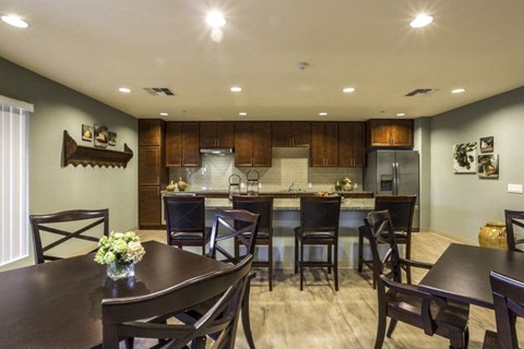 A dining room with a table set for four.