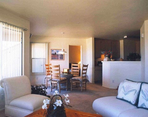A living room with a couch, chairs, and a coffee table.