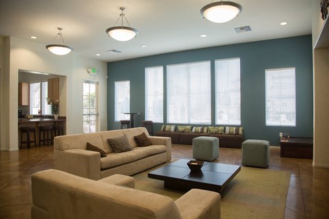 A living room with a couch, ottoman, and coffee table.
