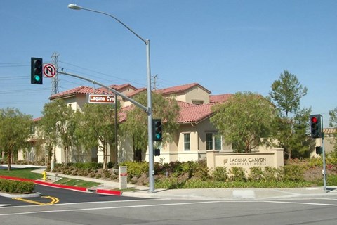 A street view of Laguna Canyon Estates with a traffic light showing green.