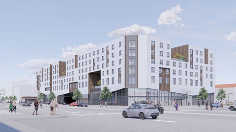 A modern building with a parking lot in front of it.