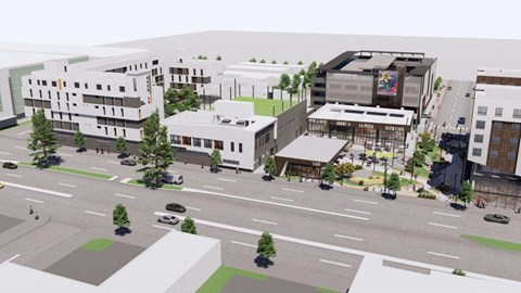 A street view of a city with buildings, cars, and trees.