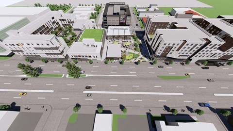 A street view of a city with buildings, cars, and trees.