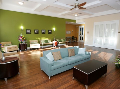 A living room with a green couch and a coffee table.