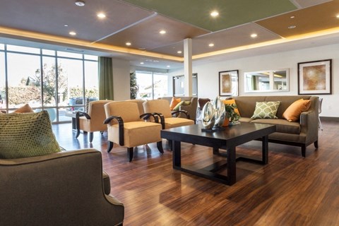 A living room with a brown sofa and a coffee table.