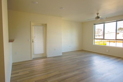 A room with wooden floors and a ceiling fan.