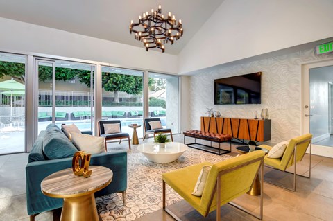 A living room with a yellow chair and a wooden table.