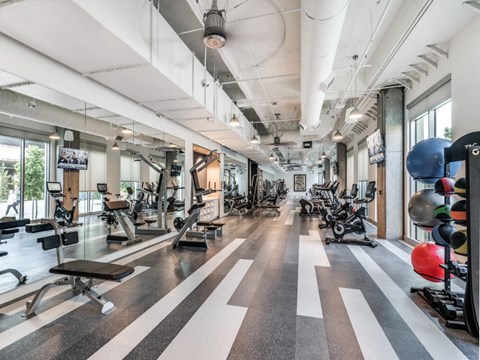 a spacious fitness center with treadmills and other exercise equipment