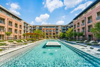 a swimming pool with chaise lounge chairs and a gazebo in front of a