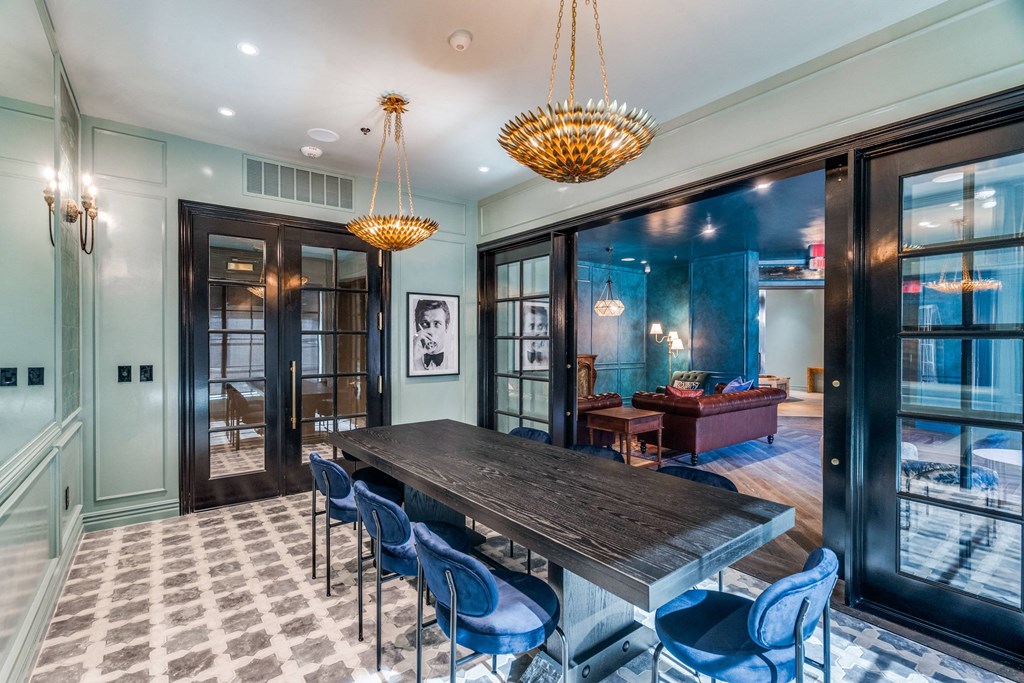 a dining room with a long wooden table and blue chairs
