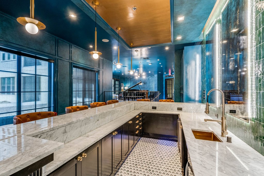 a large kitchen with marble counter tops and a sink