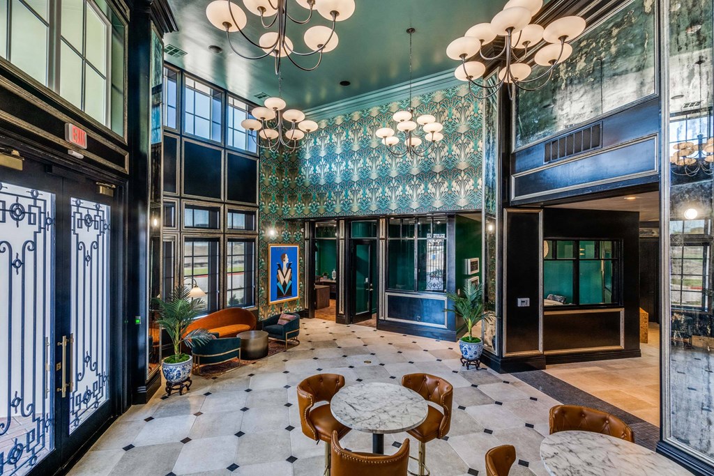 a lobby with blue walls and tables and chairs