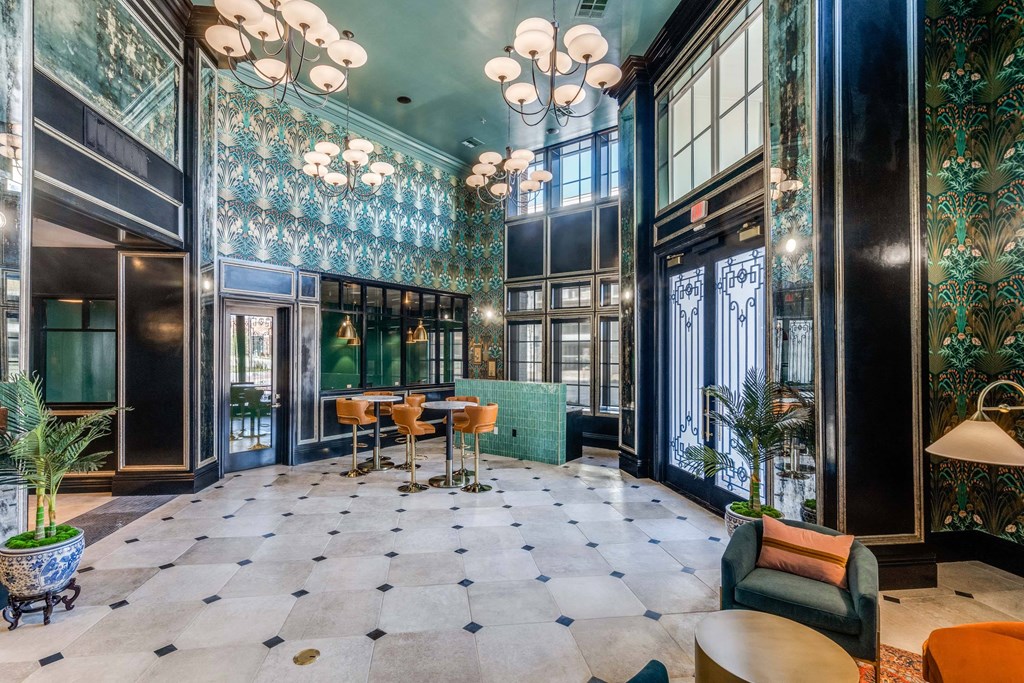 a lobby with blue and green walls and a table and chairs