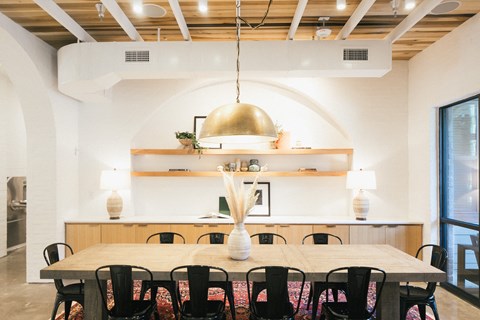 A dining room with a wooden table and chairs.