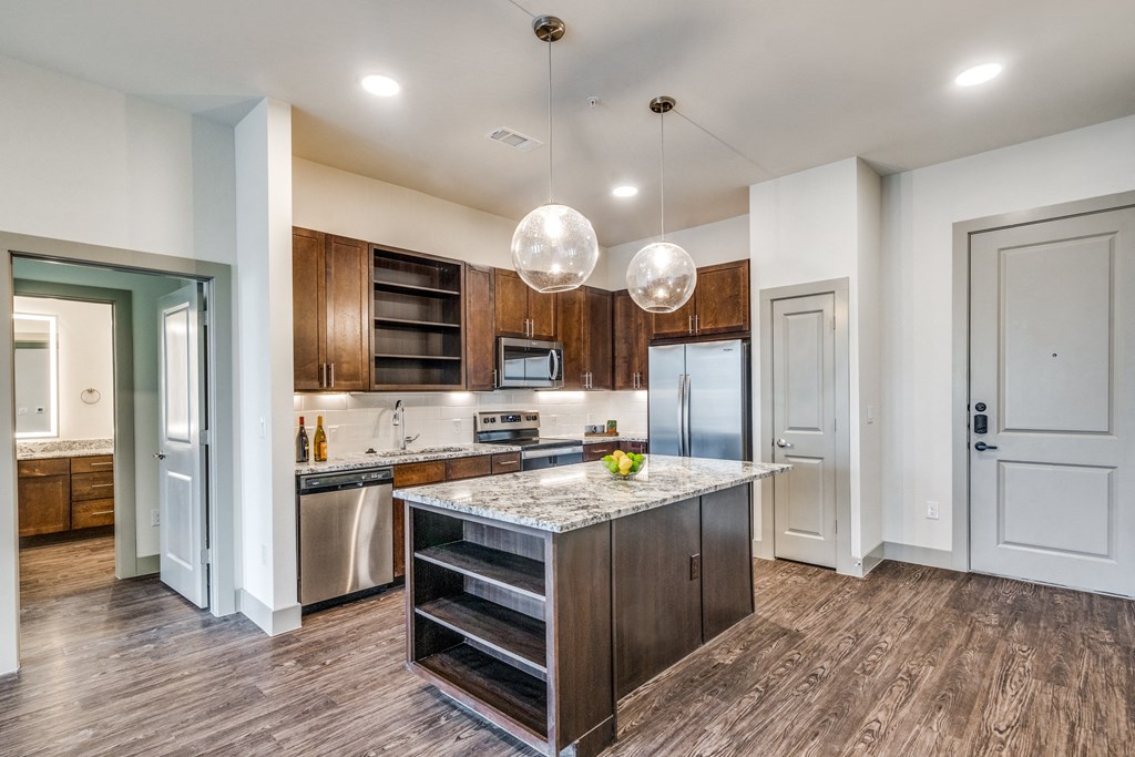 a kitchen with a large island with a marble countertop