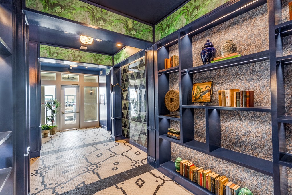 a hallway with blue walls and green and white wallpaper
