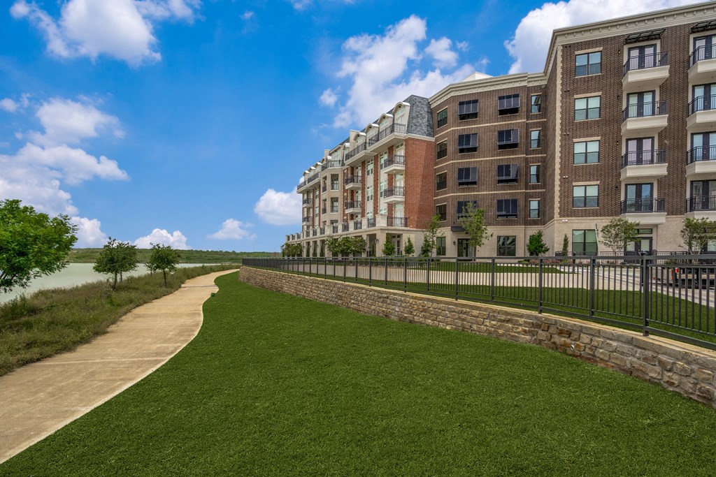 a large building with a grassy area in front of it