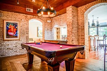 Wine room with wine bar, pool table and patio seating