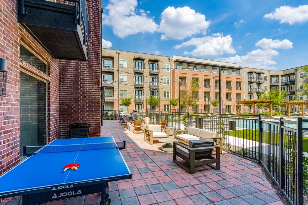 furnished patio with amenities including a ping pong table and a pool