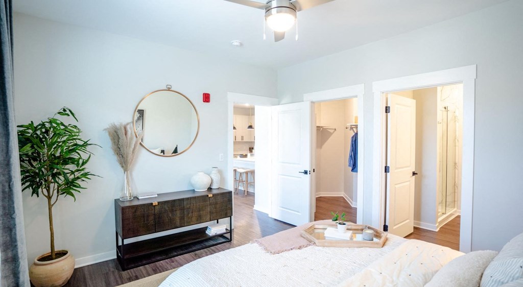 a bedroom with a bed and a mirror and a closet