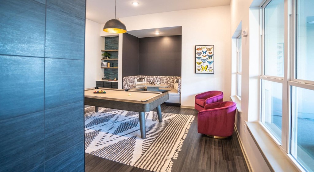 a game room with a ping pong table and a window