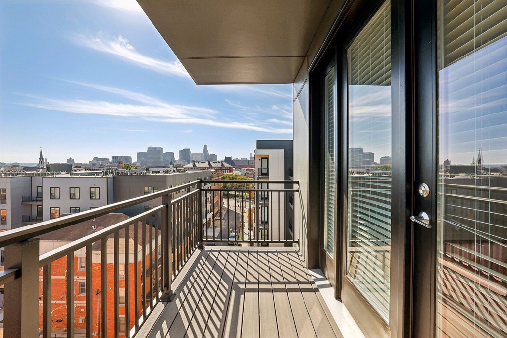 A balcony with a view of a city skyline.