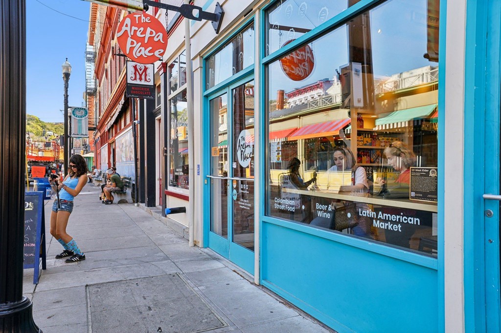 The Arepa Place and Maverick Chocolate storefronts along West Elder Street at Findlay Market near Contrast OTR in Cincinnati, OH.