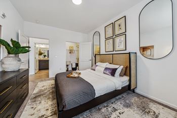 a bedroom with a large bed and a mirror  at Plat 4 at Research Triangle, Durham, 27703
