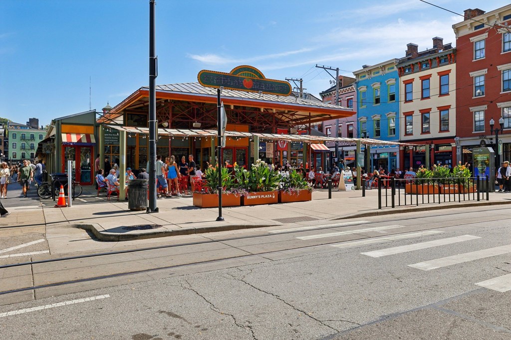 Findlay Market outdoor dining area in Over-the-Rhine Cincinnati filled with visitors and surrounded by local restaurants near Contrast OTR.