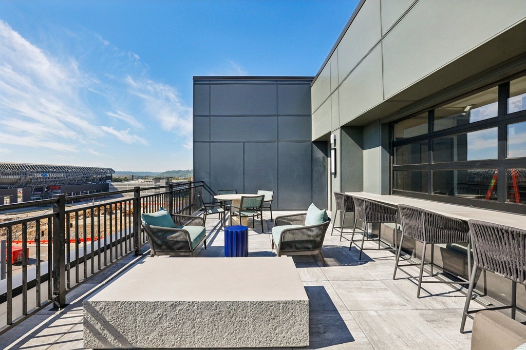 A patio area with chairs and a table.
