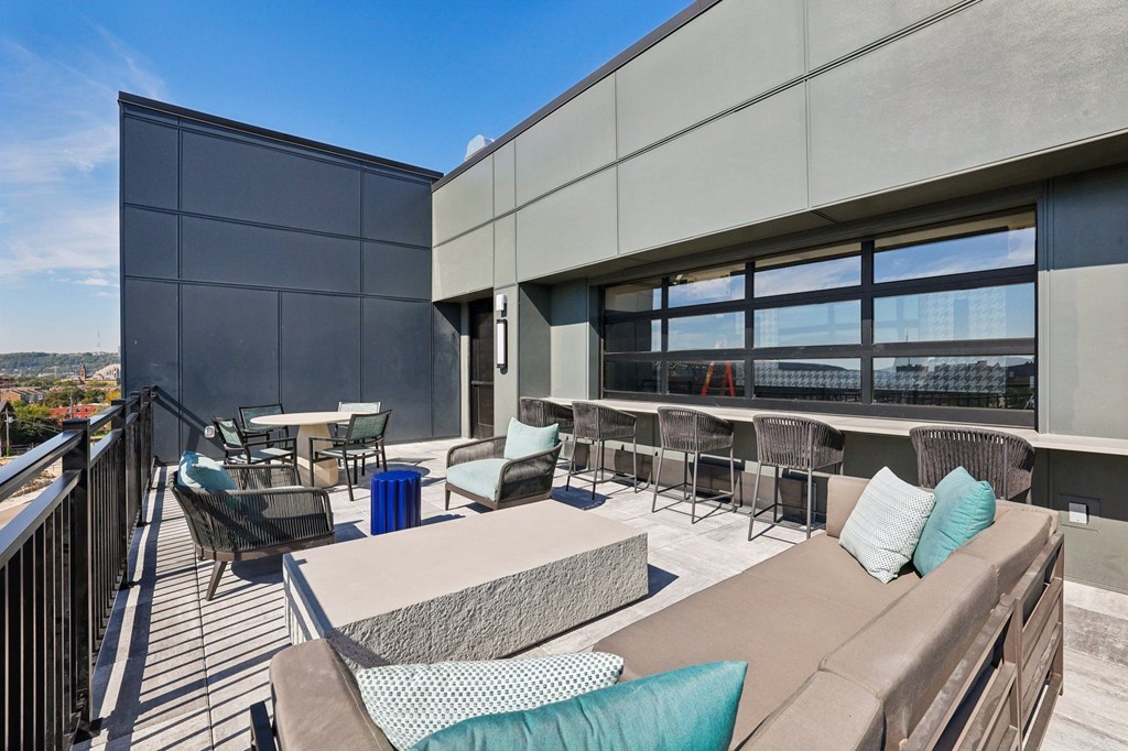 A patio with a couch, chairs, and a table.