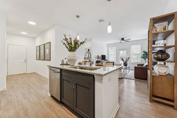 a kitchen with an island and a living room with a couch  at Plat 4 at Research Triangle, North Carolina, 27703