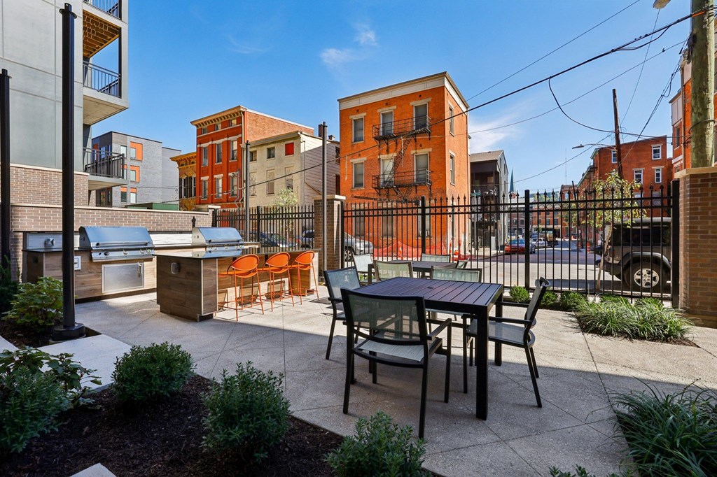 Patio lounge area at Contrast OTR apartments in Over-the-Rhine featuring modern furniture and outdoor fireplace.