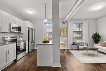 A modern kitchen with white cabinets and stainless steel appliances at CityWay Apartments, Indianapolis, 46204