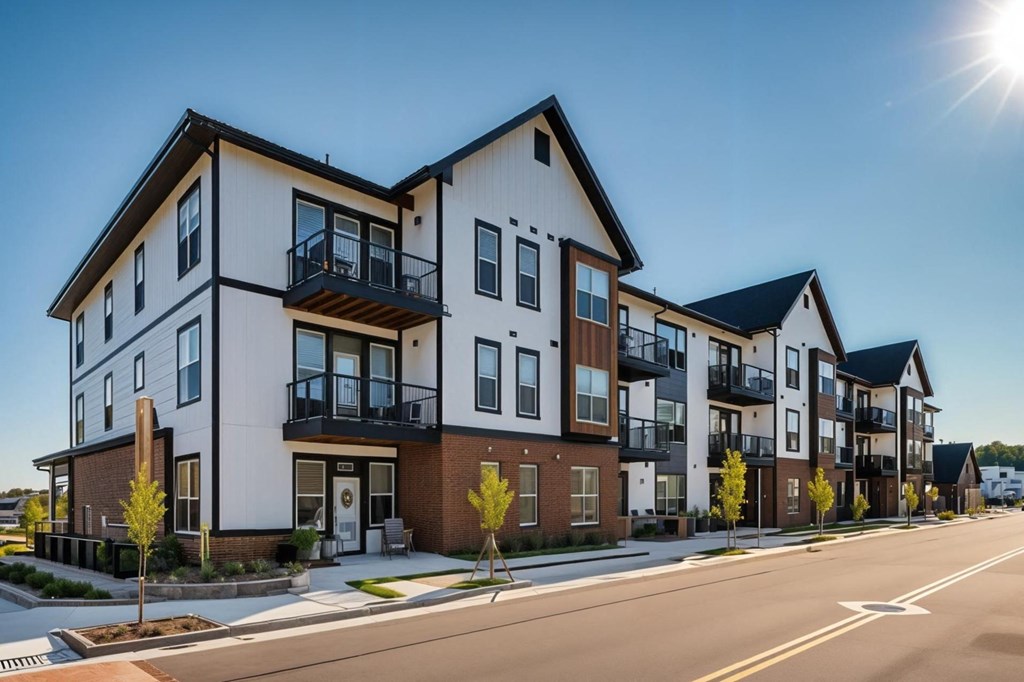 A sunny day in a quiet street with apartment buildings on the side.