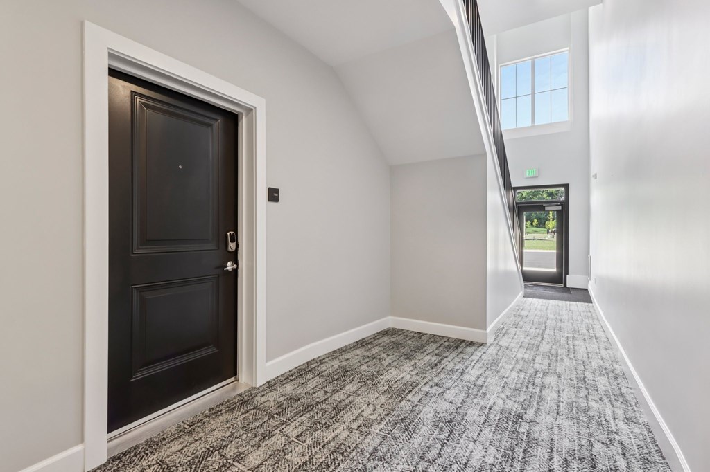 Interior hallway with unit entry at Nook Nine Apartments