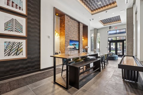 A modern dining area with a long table and chairs.