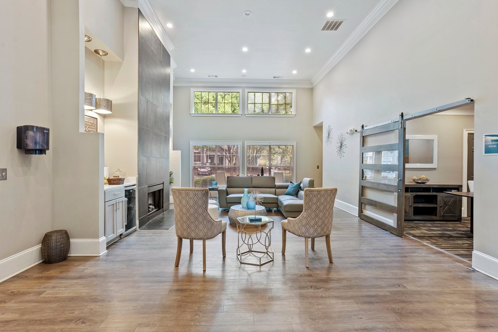 Elegant clubhouse entrance with seating and coffee station at Village at Almand Creek.