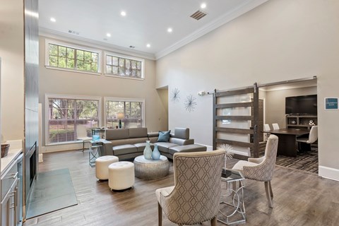 A living room with a grey sofa and a patterned armchair.