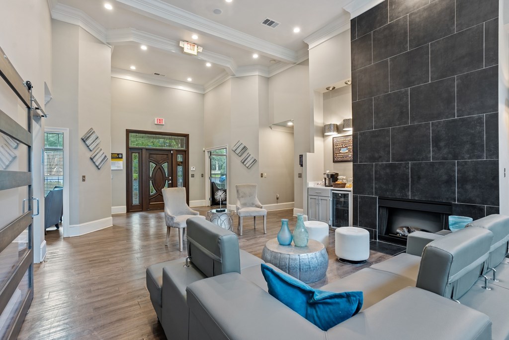 Contemporary clubhouse lounge with fireplace and gathering area in Conyers, GA apartments.