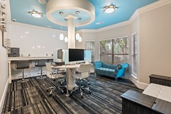 A room with a blue ceiling and a desk with a computer on it.
