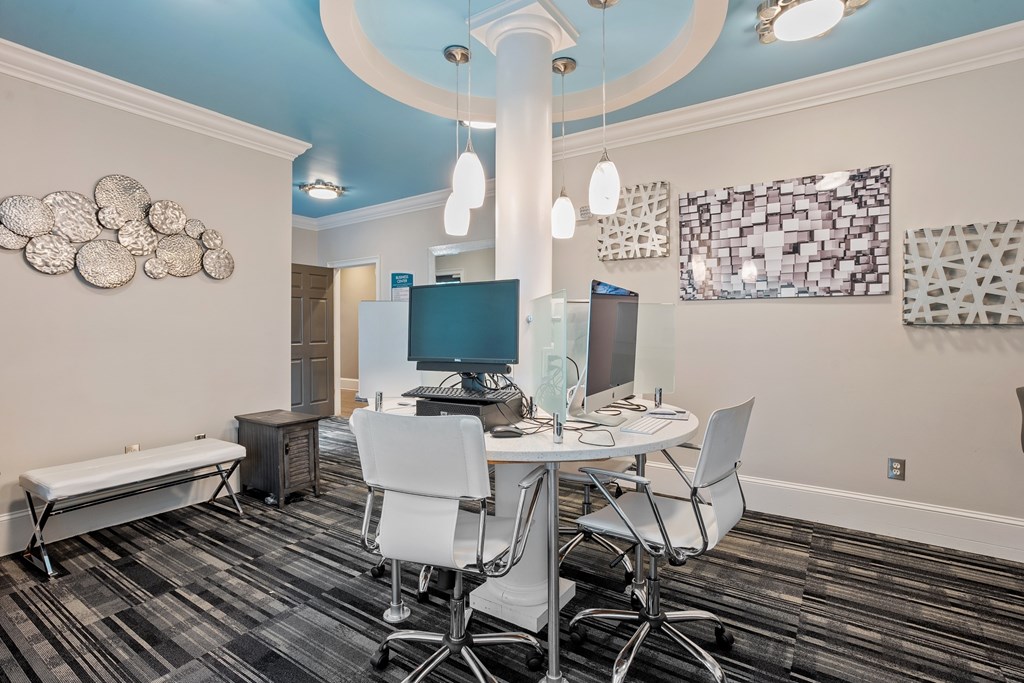 Resident computer lounge with blue accent ceiling and multiple workstations at Village at Almand Creek.