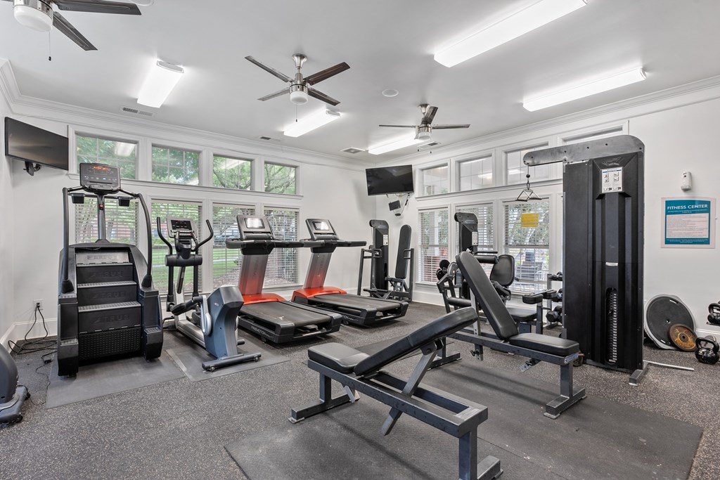 Cardio and strength training machines in the fitness center at Village at Almand Creek.