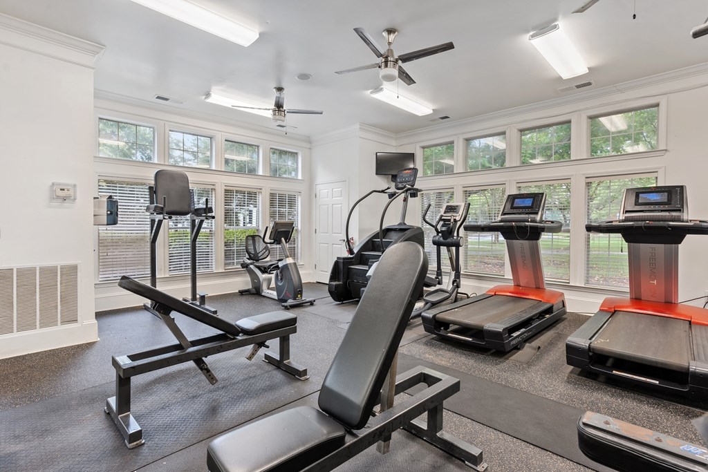 24-hour fitness center with cardio machines and strength equipment at Village at Almand Creek.