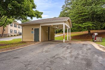 A parking lot in front of a building with a green door.