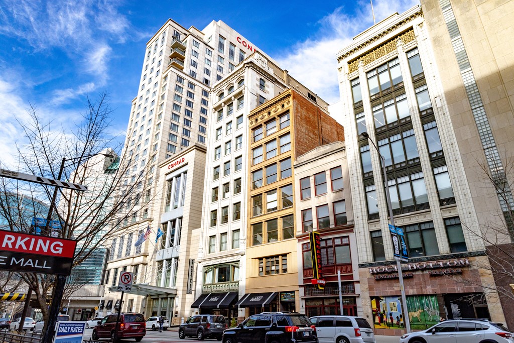a city street with tall buildings and a blue sky in the background at 26 West, Managed by Buckingham Urban Living, Indianapolis