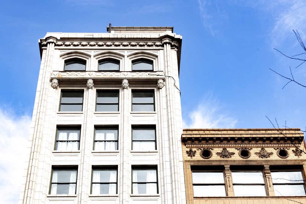 the top of a tall white building with a blue sky in the background at 26 West, Managed by Buckingham Urban Living, Indianapolis